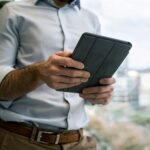 person holding black smart cover during daytime